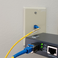 Media Converter with the jumper plugged into the wall at a customers house